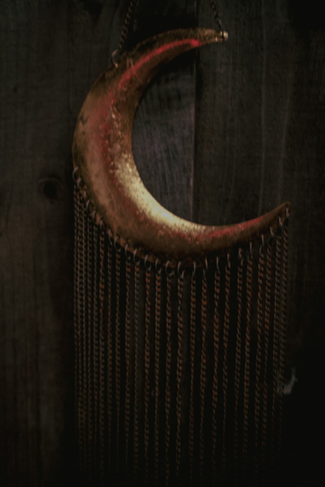 A brass crescent moon marking the Moon Tub