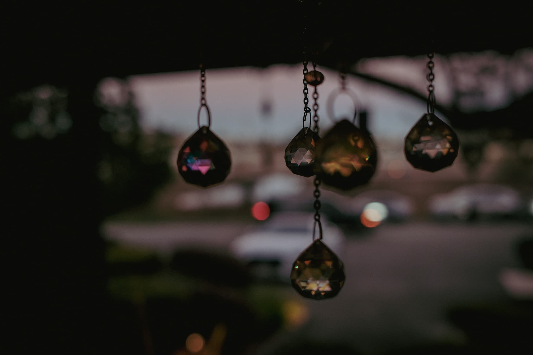 Small hanging prisms catching the light near the entrance