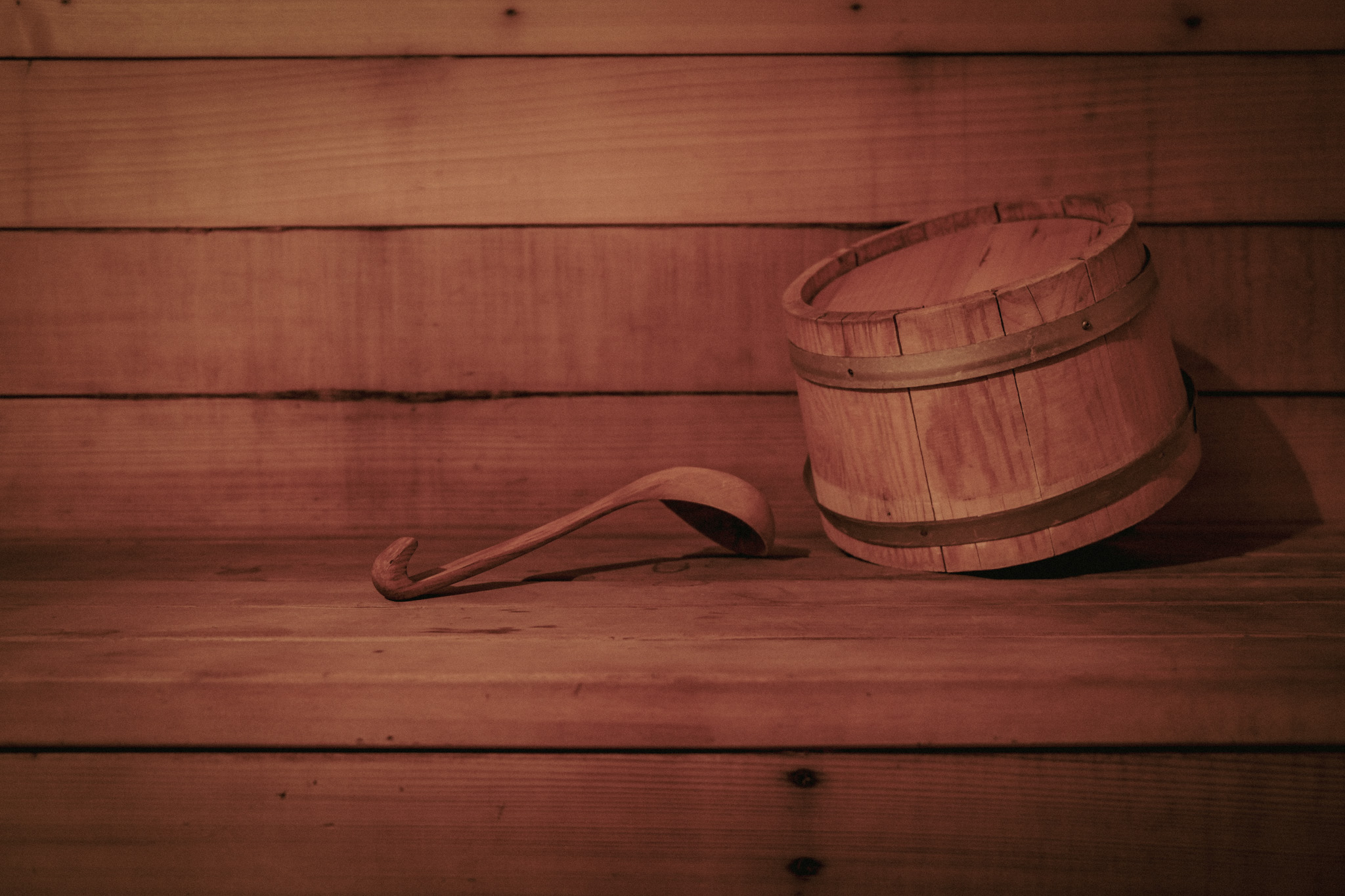 A wooden bucket and ladle inside the traditional Finnish sauna