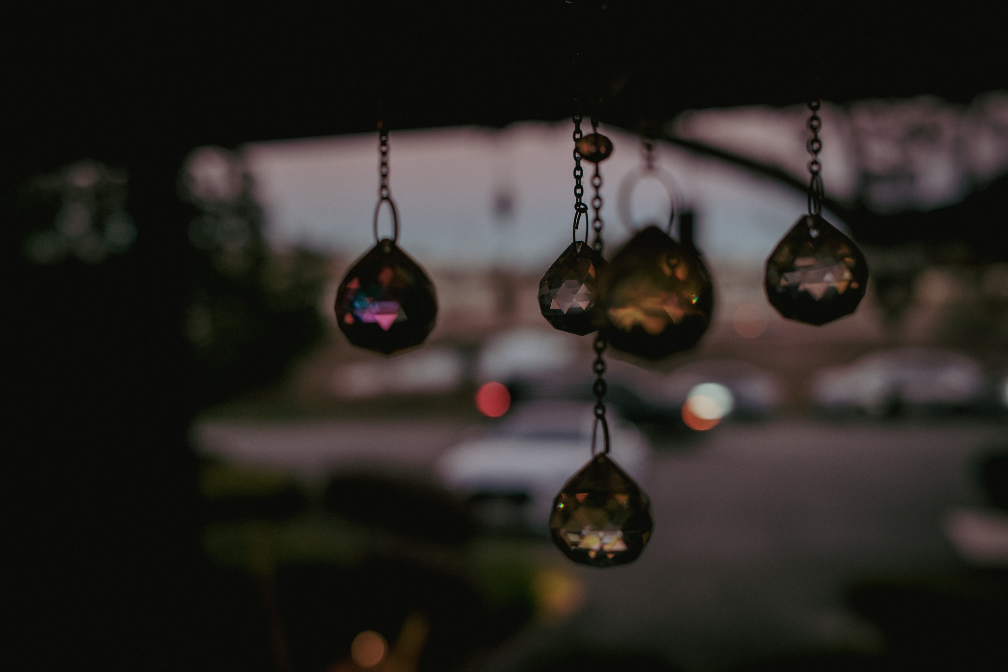 Small hanging prisms catching the light near the entrance